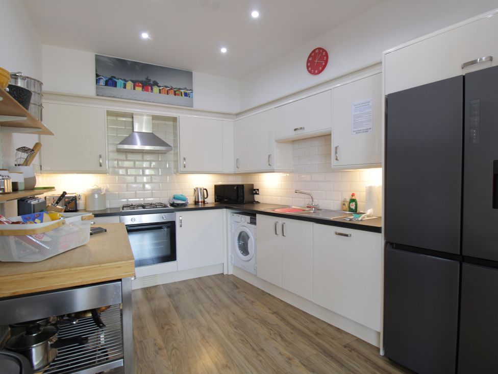A kitchen with appliances and storage at 11 Cove View Apartments in Ilfracombe