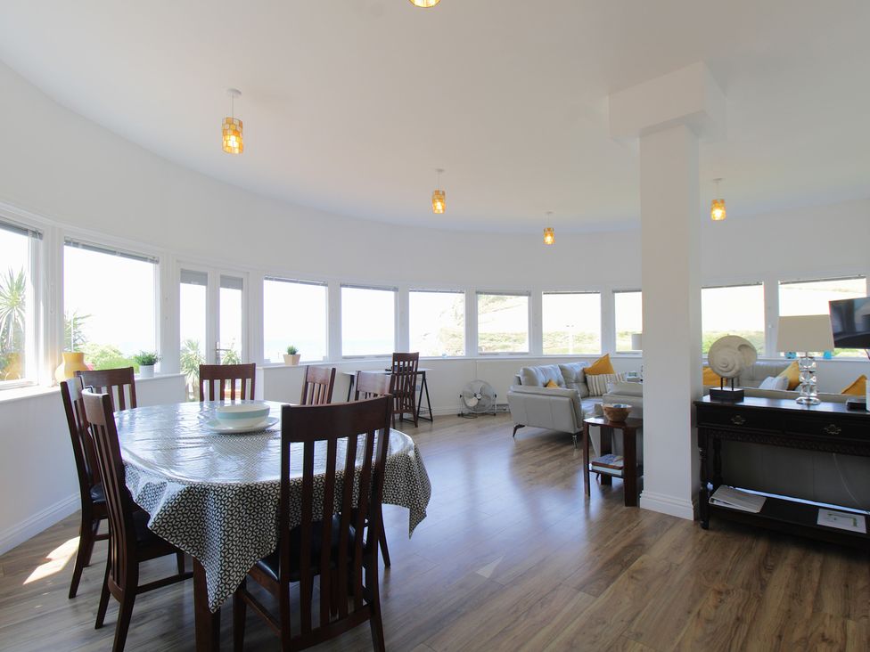 A dining room with a table and chairs at 11 Cove View Apartments Ilfracombe
