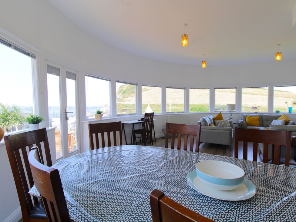 A dining room with table and chairs at 11 Cove View Apartments Ilfracombe