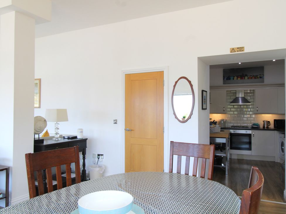 A dining room with a table and chairs at 11 Cove View Apartments Ilfracombe