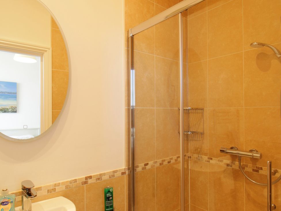 A bathroom with a shower and sink at 11 Cove View Apartments Ilfracombe