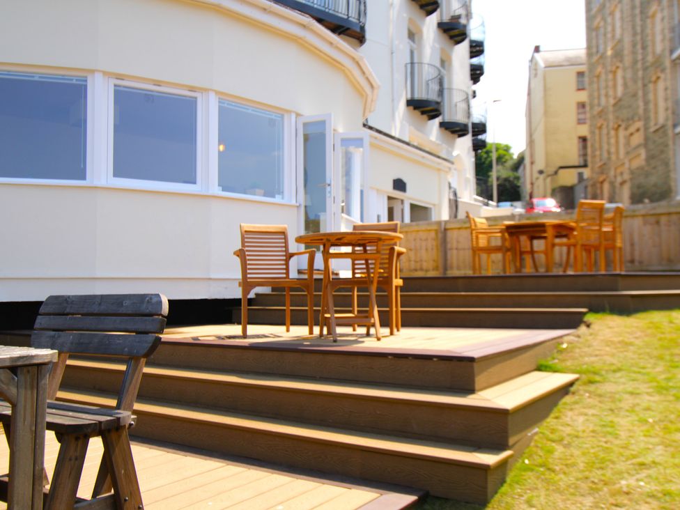 An outdoor area with chairs and tables at 11 Cove View Apartments Ilfracombe