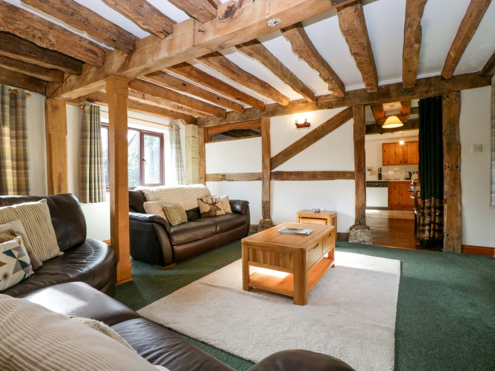 A living room with sofas and a coffee table at Redstart Cottage in Kingsland