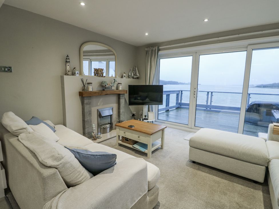 A living room with a sofa and television at White Sails Y Felinheli
