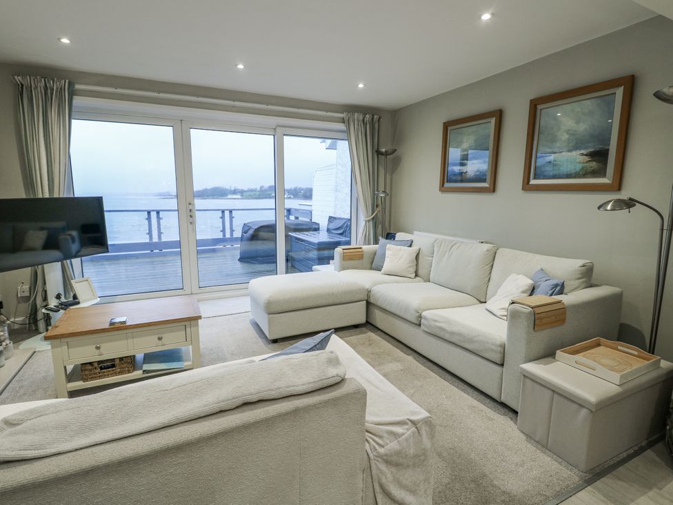 A living room with a sofa and television at White Sails Y Felinheli