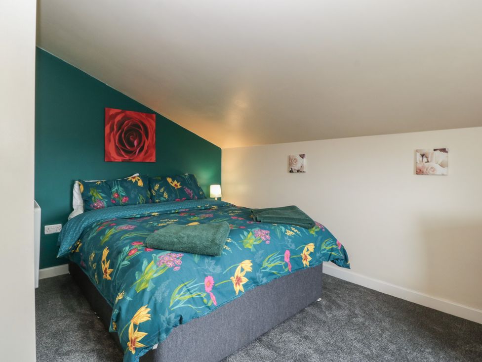 A bedroom with a bed and decorative items at Top Lodge Llanvair-Discoed near Penhow