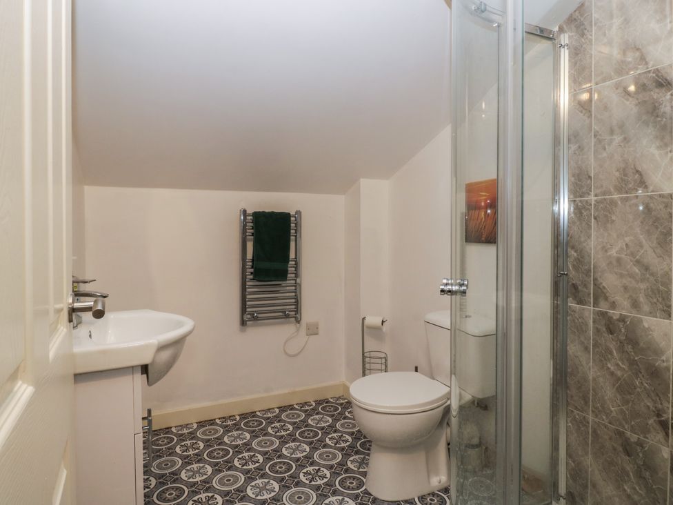 A bathroom with a sink, toilet, and shower at Top Lodge in Llanvair-Discoed near Penhow