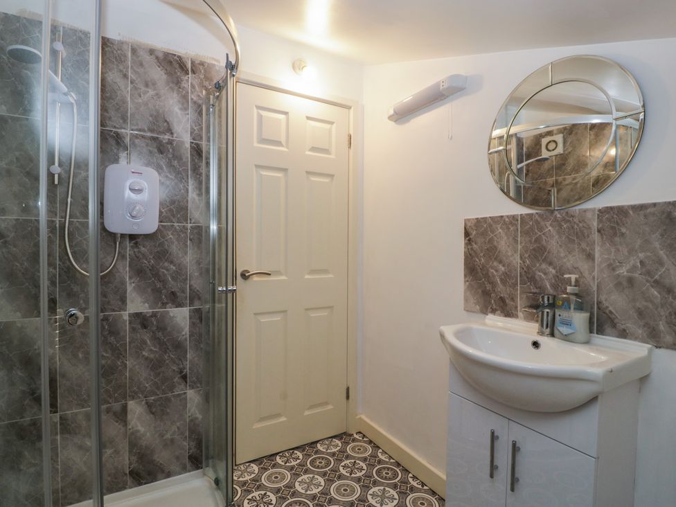 A bathroom with a shower and sink at Top Lodge Llanvair-Discoed near Penhow