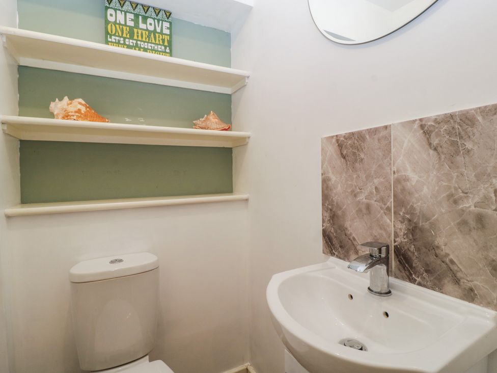 A bathroom with a toilet and sink at Top Lodge Llanvair-Discoed near Penhow