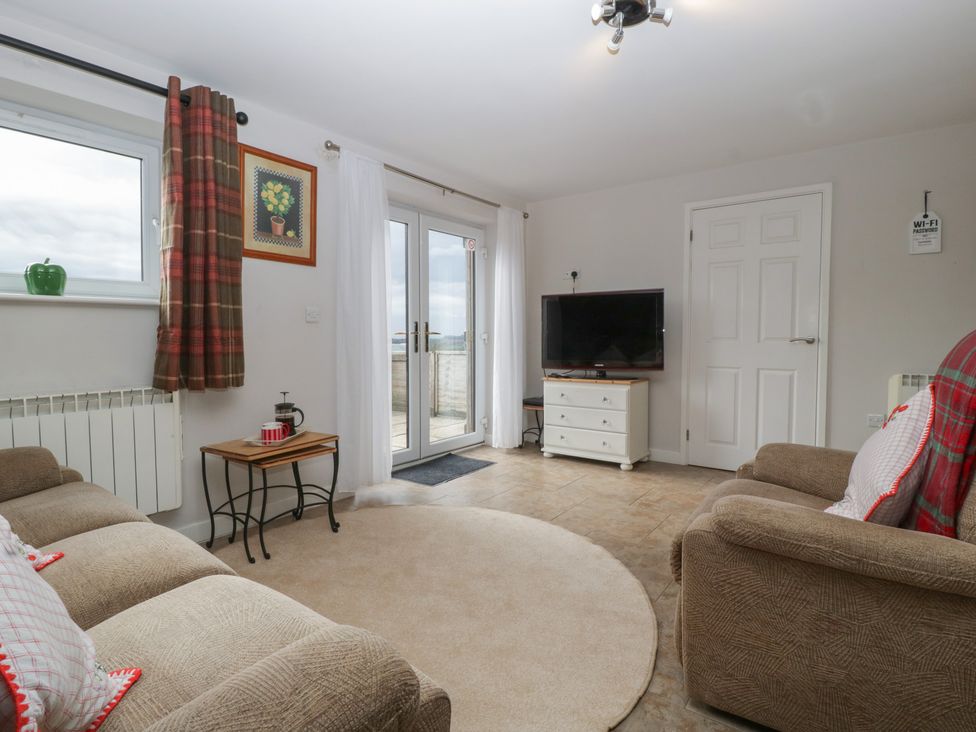 A living room with a TV and sofa at Top Lodge in Llanvair-Discoed near Penhow