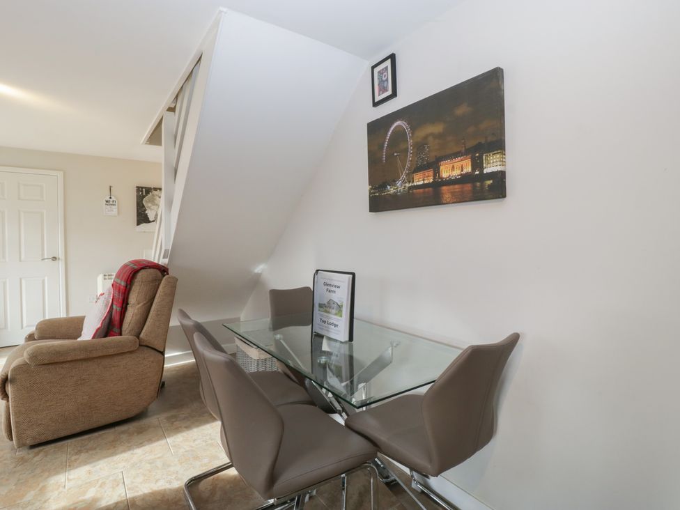 A dining room with a table and chairs at Top Lodge in Llanvair-Discoed near Penhow