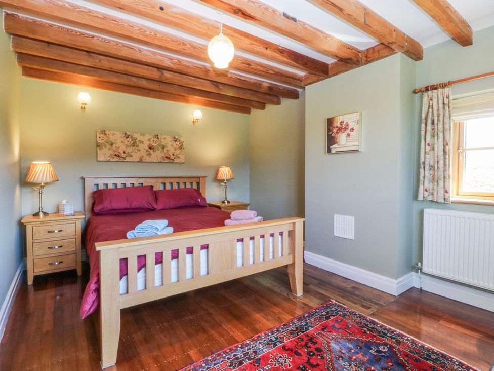 A bedroom with a bed and bedside tables at Bronfa in Tregarth