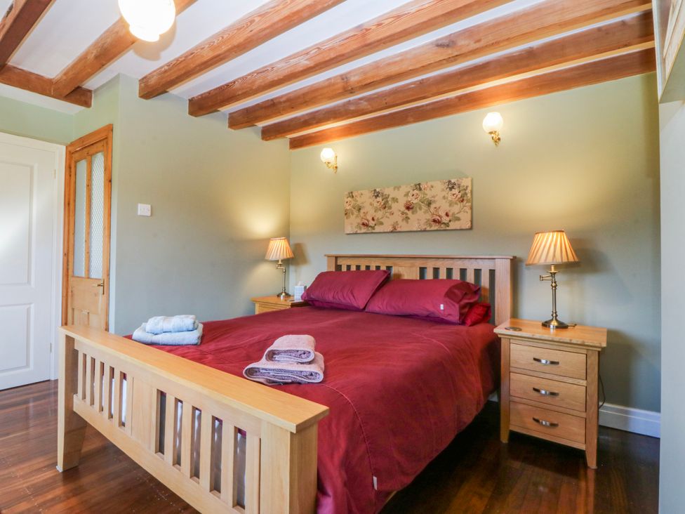 A bedroom with a bed and bedside tables at Bronfa in Tregarth