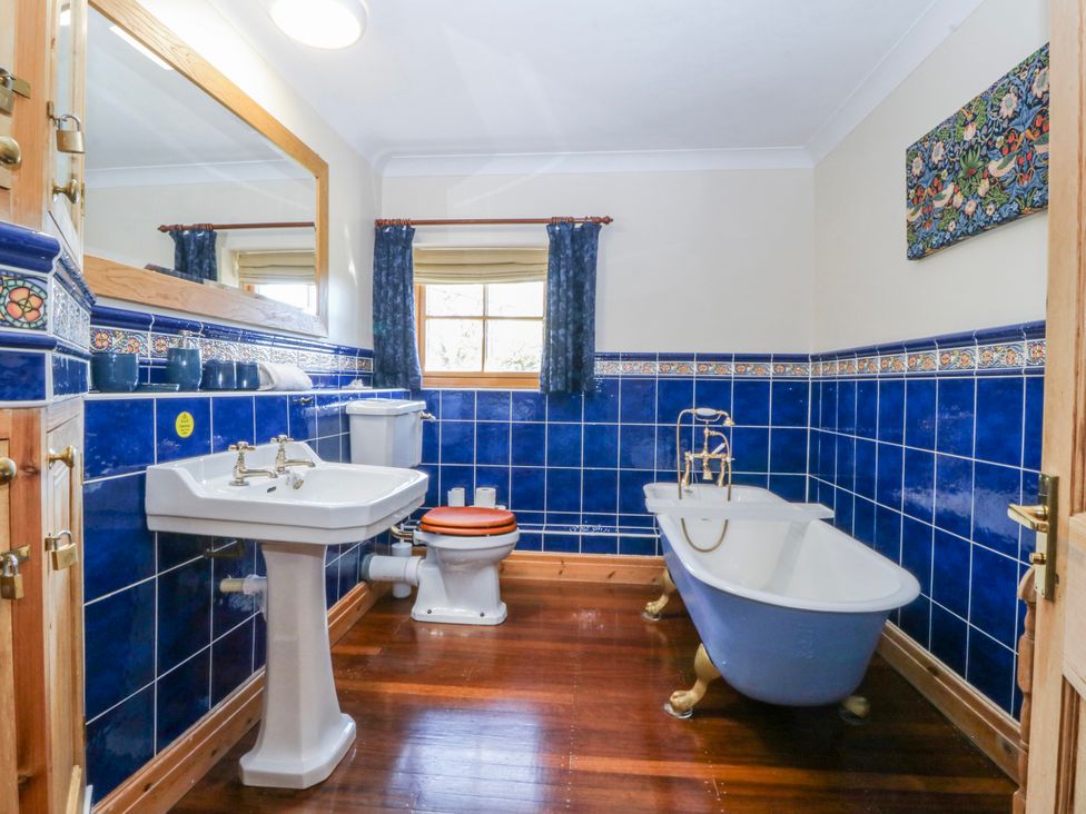 A bathroom with a bathtub and sink at Bronfa in Tregarth