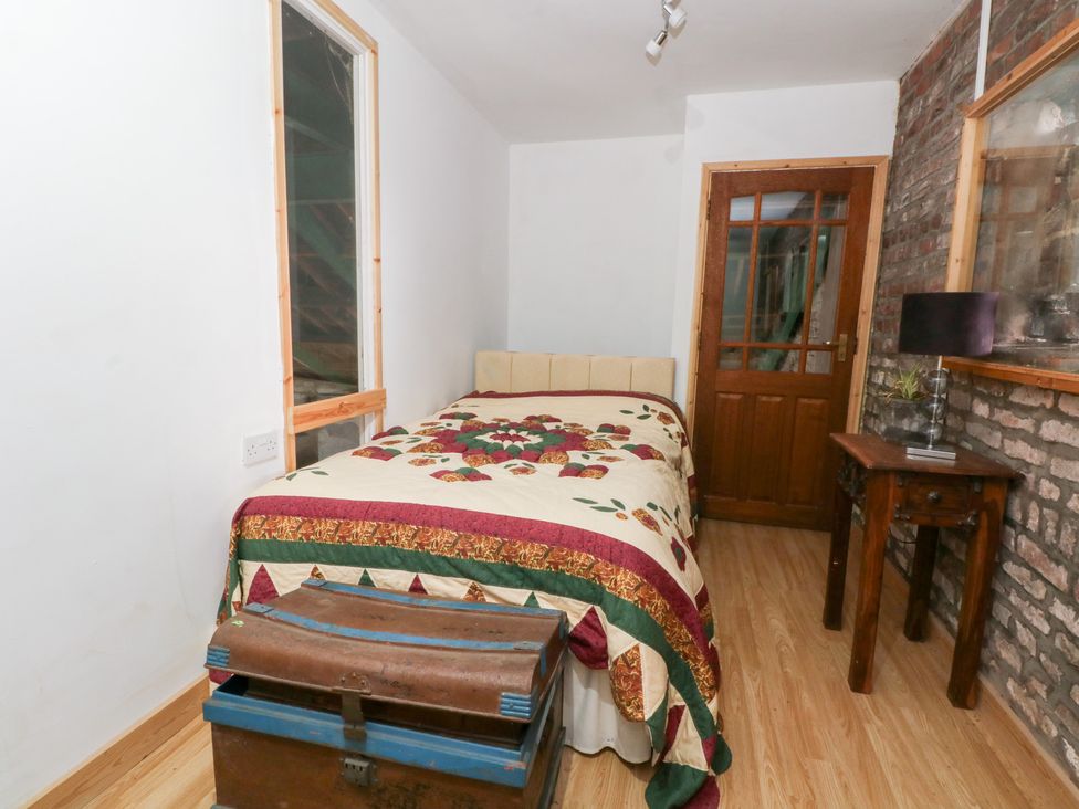 A bedroom with a bed and a trunk at The Toolshed in Birchwood