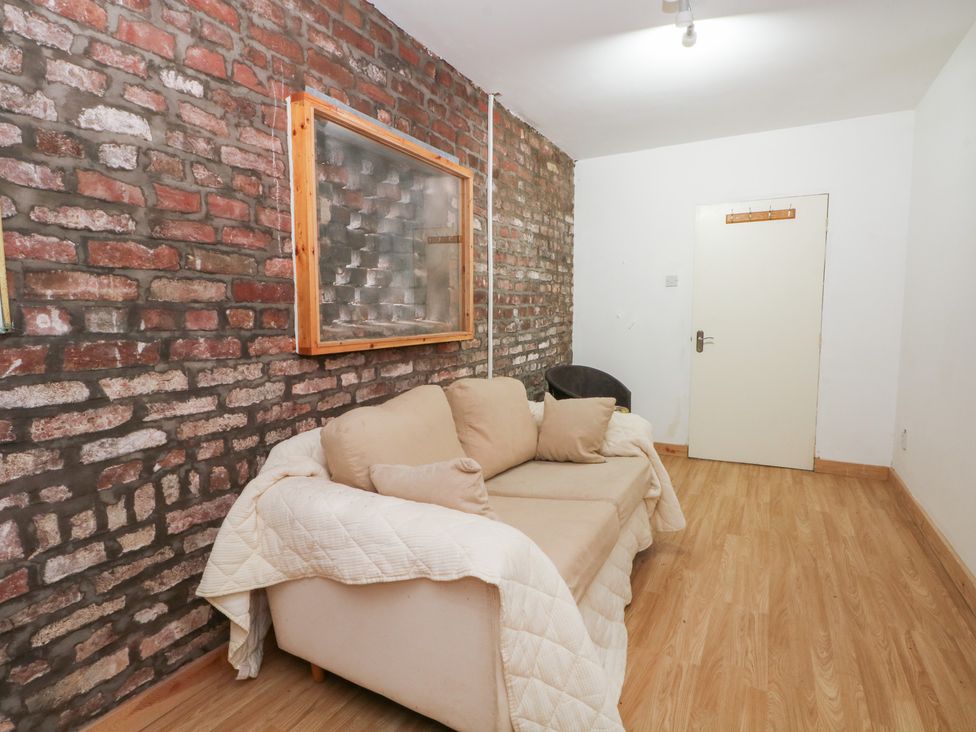 A living room with a sofa and a door at The Toolshed in Birchwood