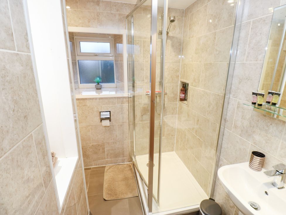 A bathroom with a shower and sink at Rosemount Cottage Barnoldswick