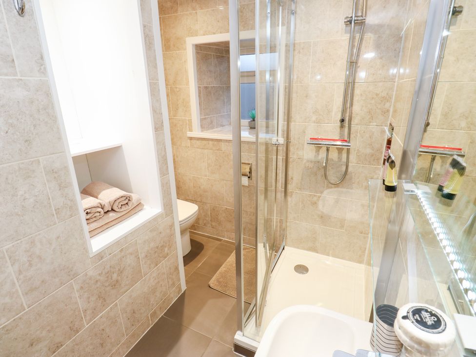 A bathroom with a shower and sink at Rosemount Cottage in Barnoldswick