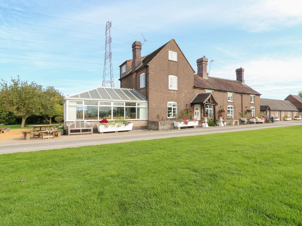 A house with a conservatory and garden at Far Coley Farm and Kilnhurst Log Cabin Great Haywood