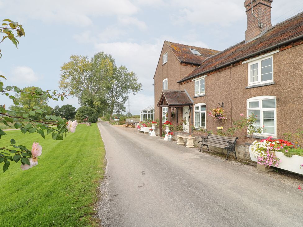A house with a road and garden at Far Coley Farm and Kilnhurst Log Cabin in Great Haywood
