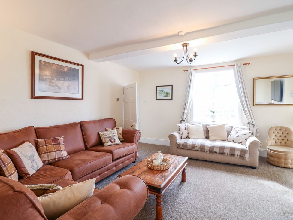A living room with a sofa and coffee table at Far Coley Farm and Kilnhurst Log Cabin Great Haywood