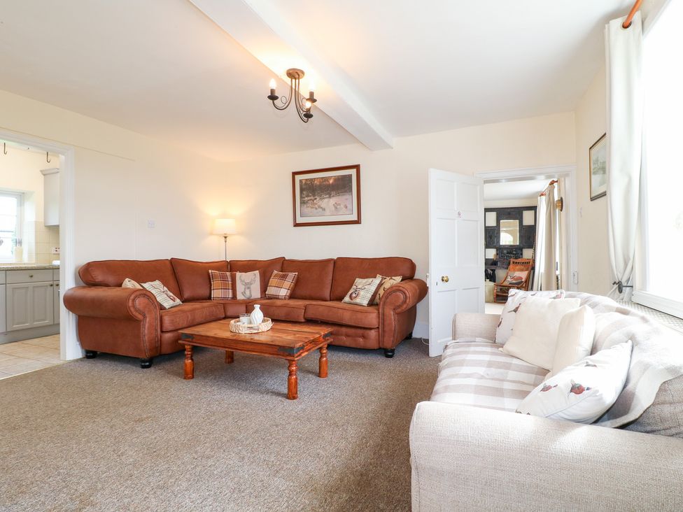A living room with sofas and a coffee table at Far Coley Farm and Kilnhurst Log Cabin Great Haywood