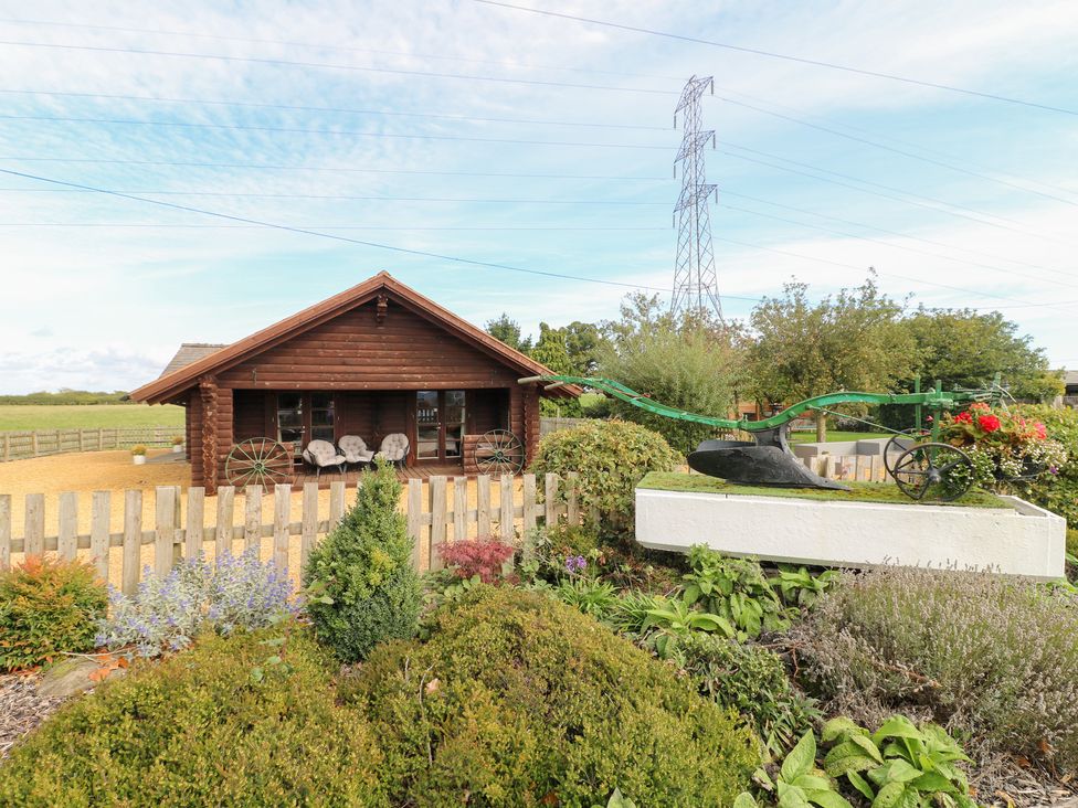 A log cabin with garden features at Far Coley Farm and Kilnhurst Log Cabin Great Haywood
