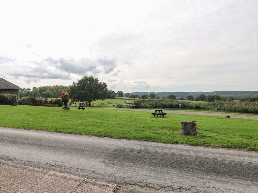 An outdoor area with grass and trees at Far Coley Farm and Kilnhurst Log Cabin Great Haywood