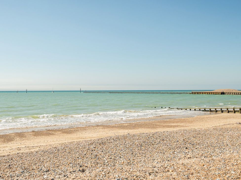 A beach with a pier extending into the ocean at Marine Court Two Bedroom Second-floor Apartment 33 Littlehampton