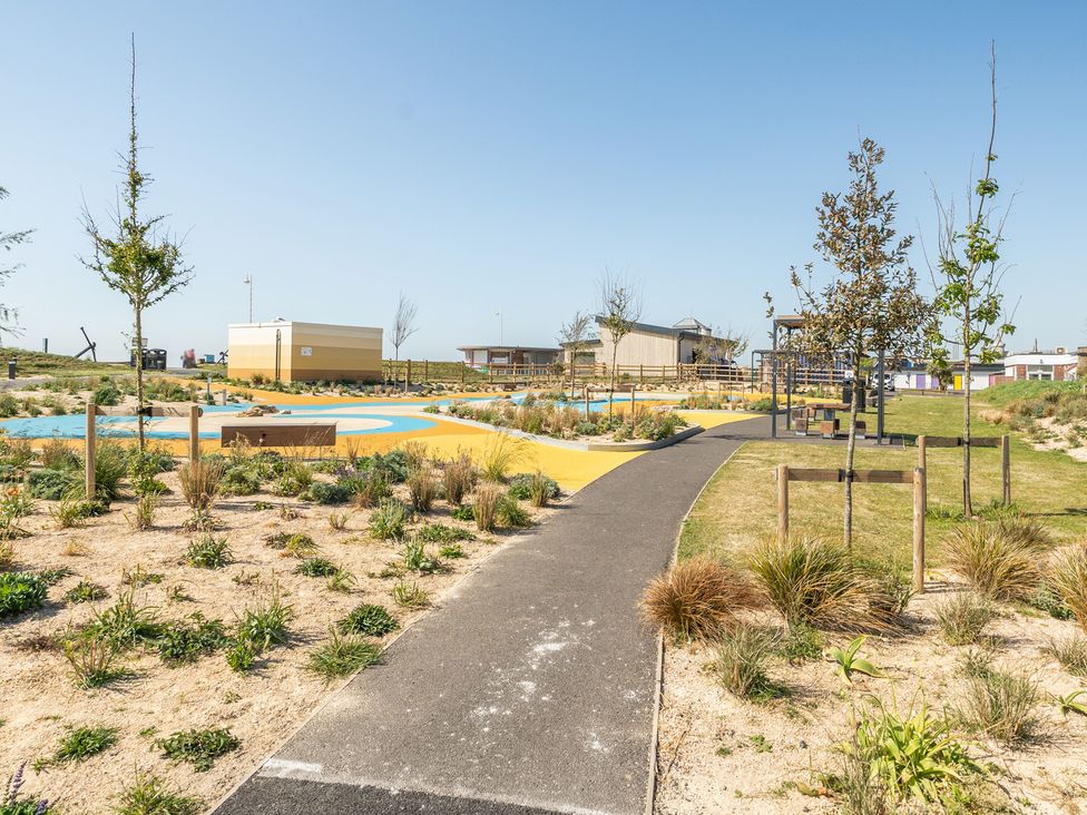 A pathway surrounded by grass and trees at Marine Court Two Bedroom Second-floor Apartment 33 Littlehampton