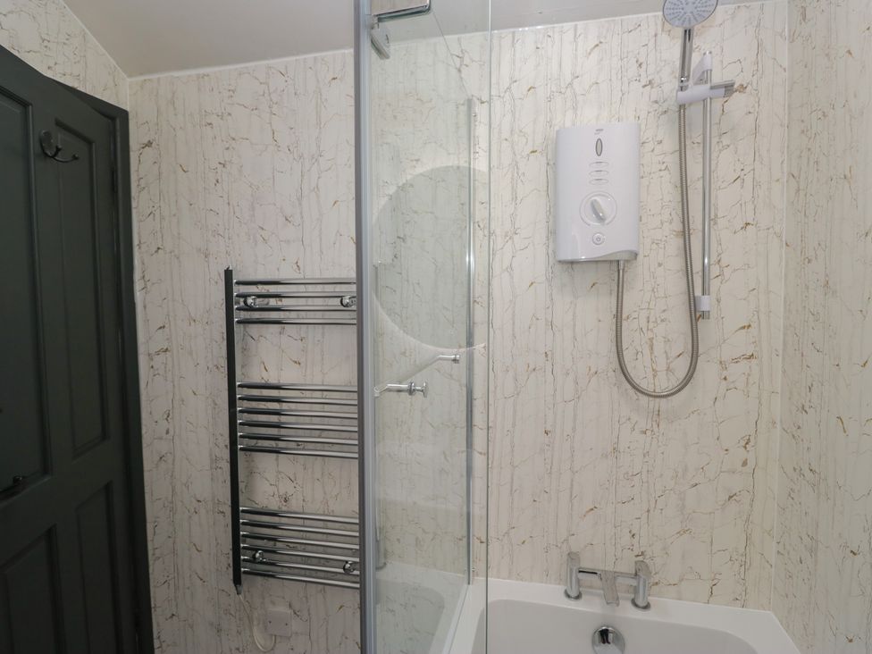 A bathroom with a shower and bathtub at Cringol Cottage Ambleside