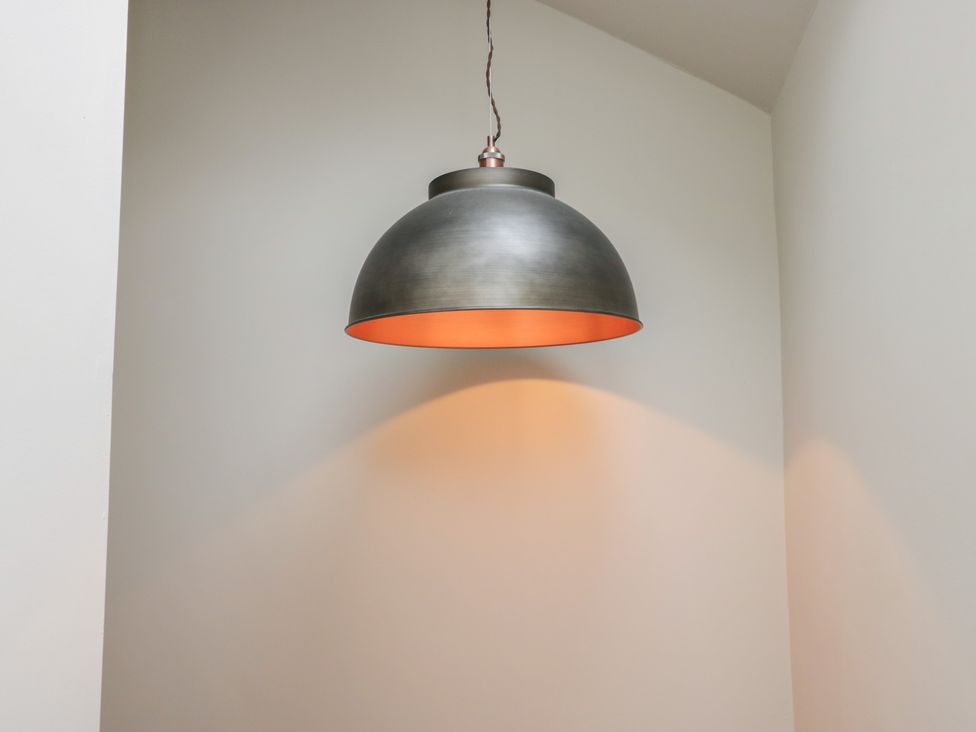 A lamp hanging from the ceiling at Cringol Cottage Ambleside