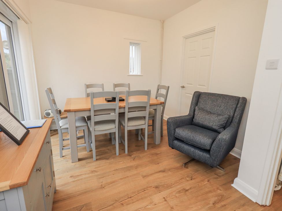 A dining room with a table and chairs at 1 Eamont Park in Penrith