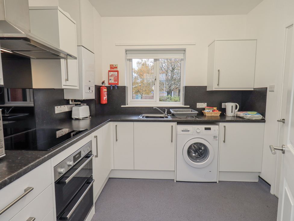 A kitchen with appliances and cupboards at 1 Eamont Park in Penrith