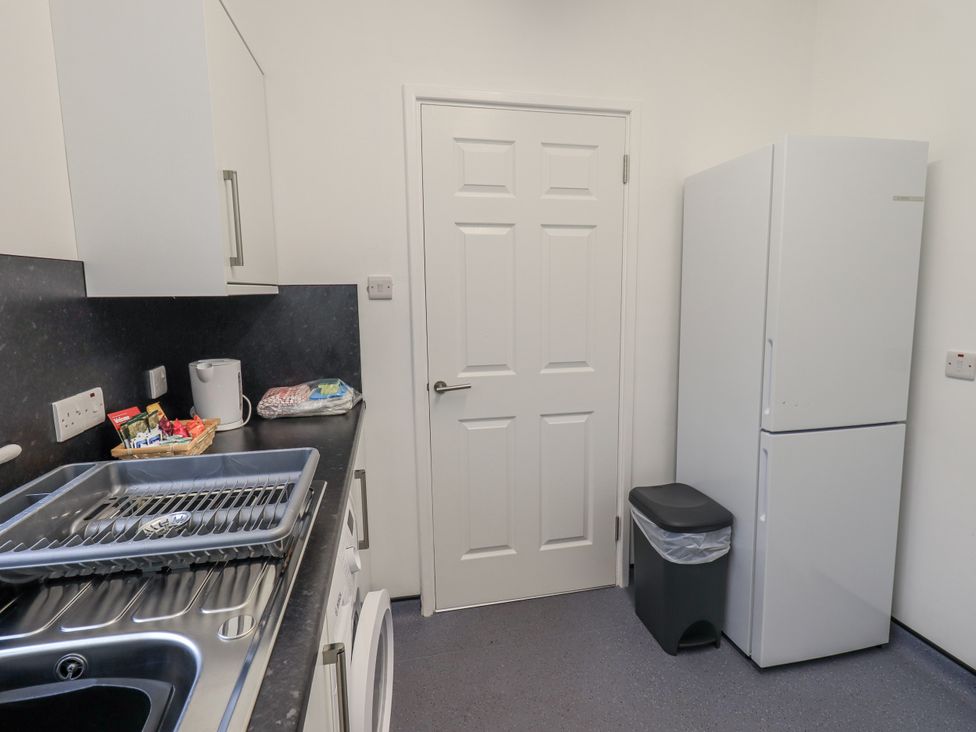 A kitchen with a fridge and sink at 1 Eamont Park Penrith