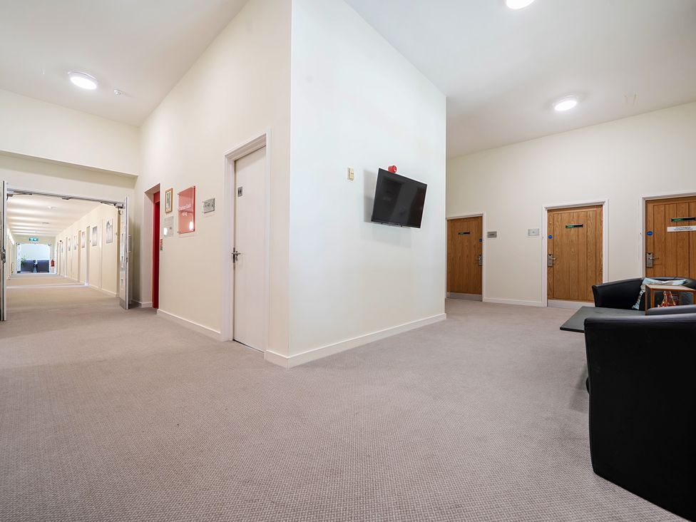 A hallway with doors and a television at Jubilee Three Bedroom House Pet Free Penrith