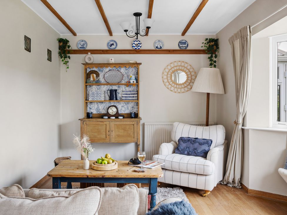 A living room with a sofa and coffee table at 7 Duporth Bay in St. Austell