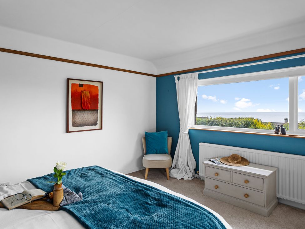 A bedroom with a bed, window and chest of drawers at 7 Duporth Bay St. Austell