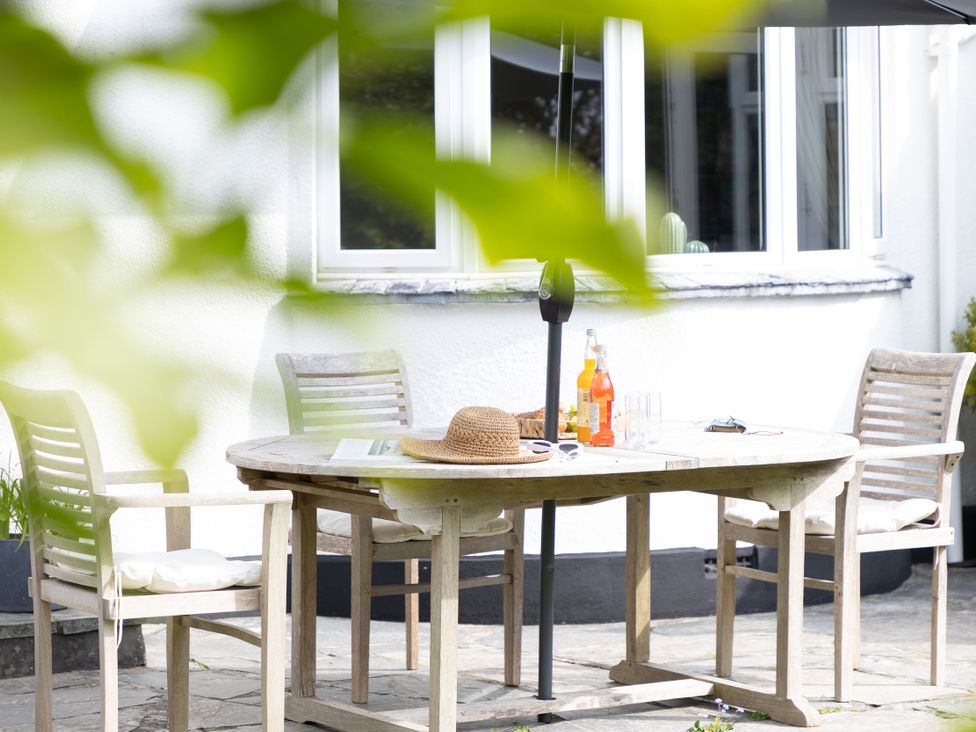 An outdoor dining area with a table and chairs at 7 Duporth Bay in St. Austell