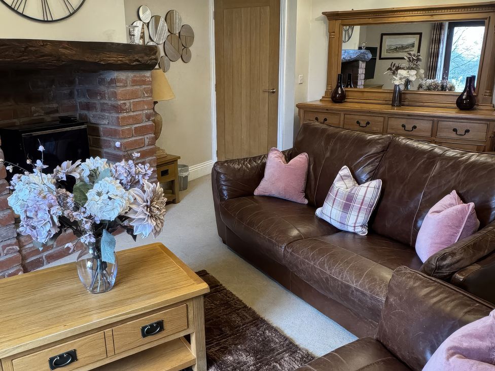 A living room with a sofa and a coffee table at Dairy Cottage Thornton in Lonsdale near Ingleton