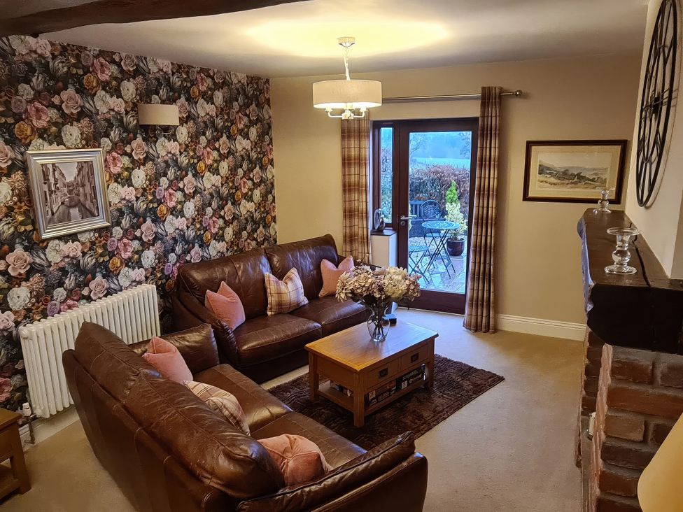 A living room with sofas and a coffee table at Dairy Cottage Thornton in Lonsdale near Ingleton