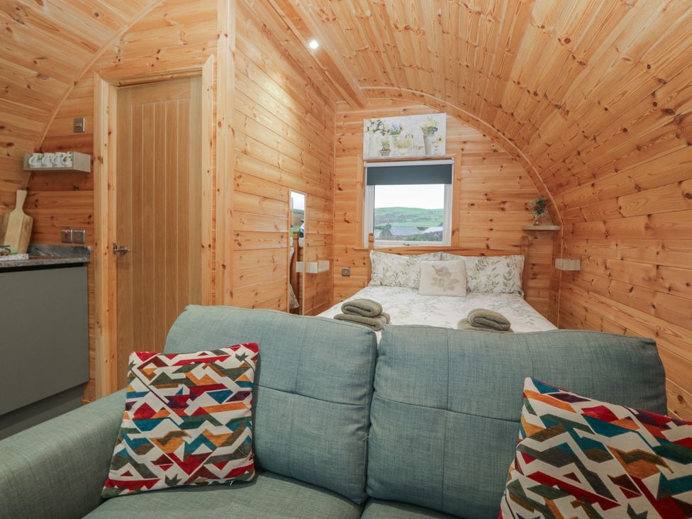 A bedroom with a bed and sofa at Beech in Ulverston