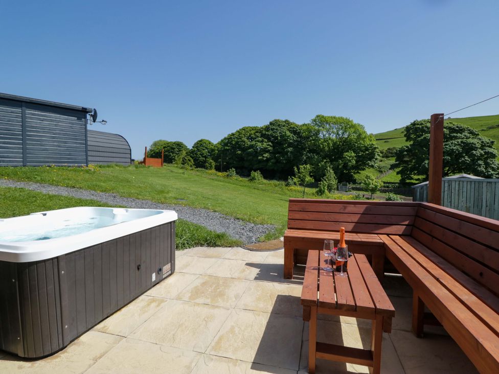 An outdoor area with a hot tub and seating at Beech in Ulverston