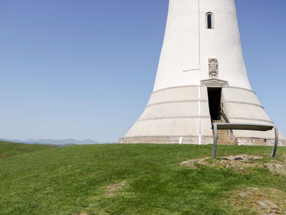 A tower with steps in a grassy landscape at Beech in Ulverston