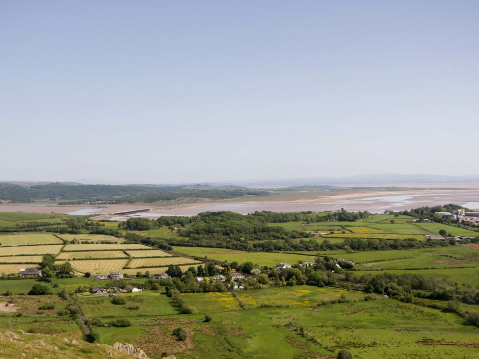 A scenic view of fields and a river with hills at Beech in Ulverston