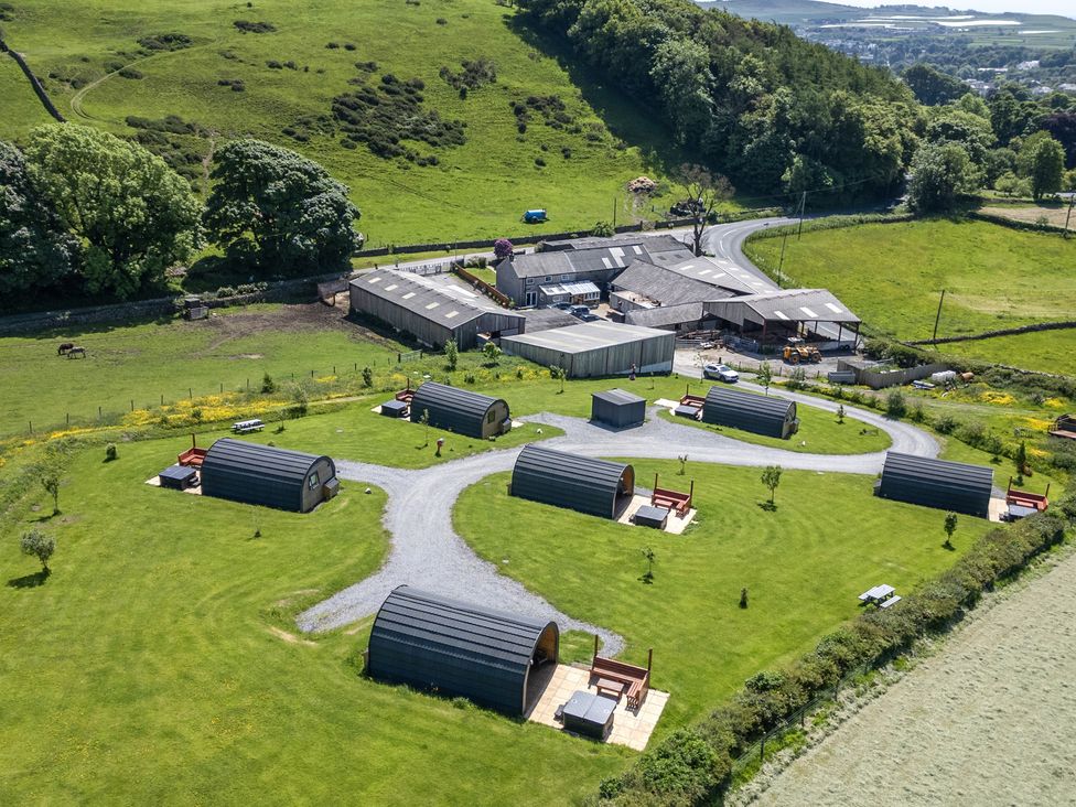 An outdoor area with glamping pods and a barn at Beech in Ulverston