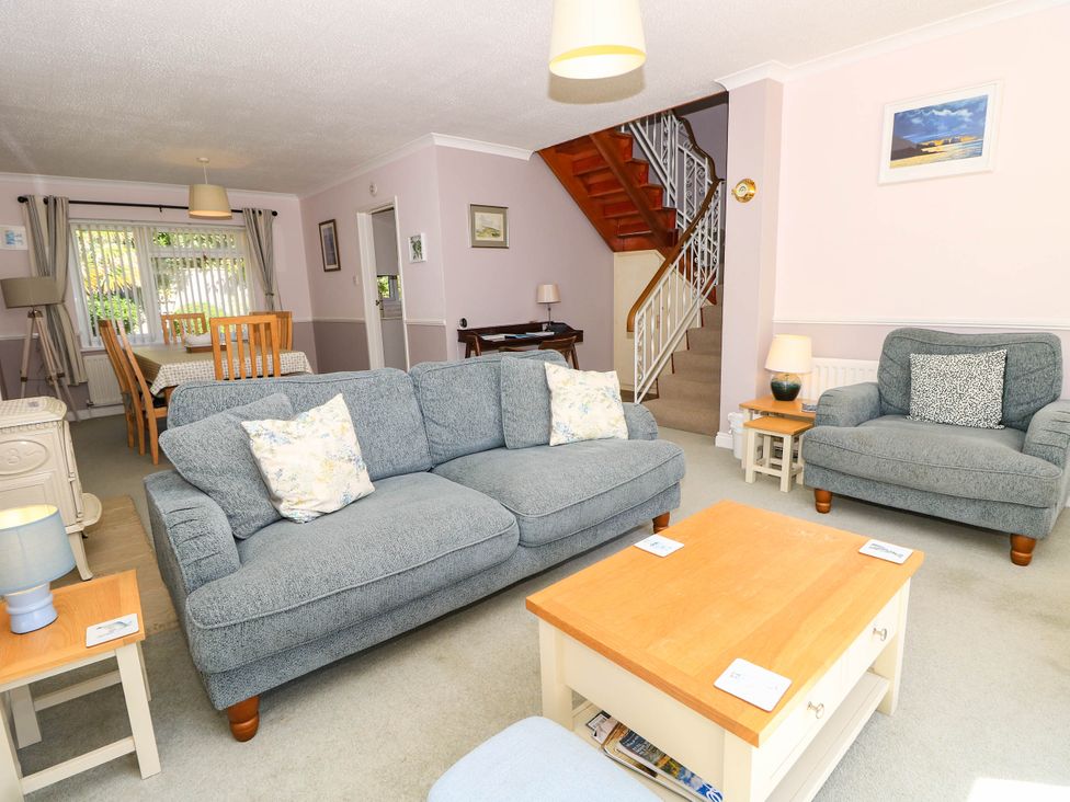 A living room with a sofa and armchair at Altair Colwell Bay near Freshwater