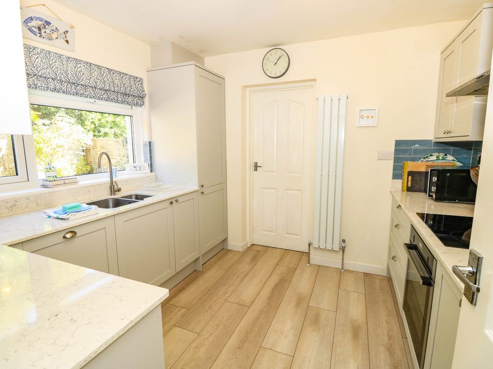 A kitchen with a sink and microwave at Altair in Colwell Bay near Freshwater