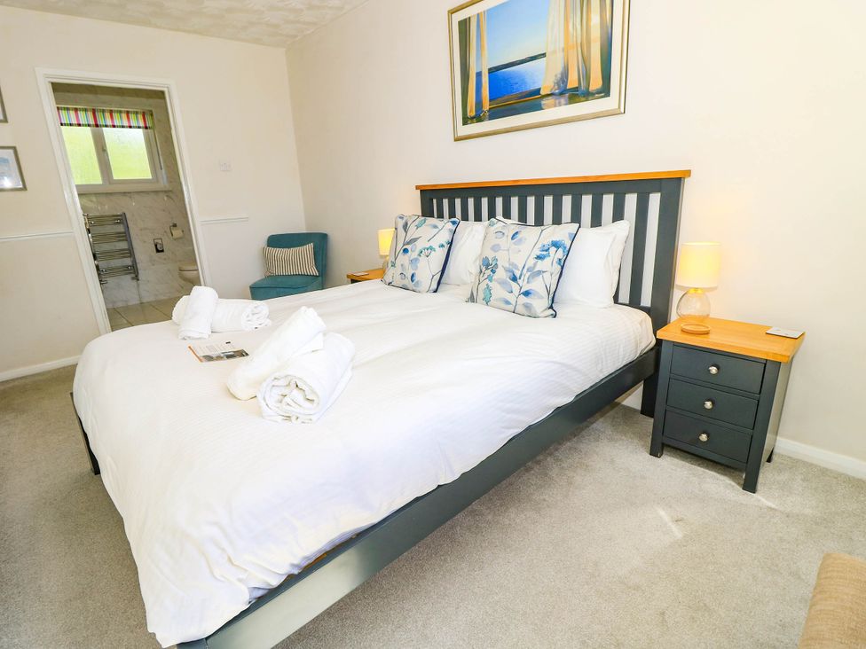 A bedroom with a bed and a bedside table at Altair Colwell Bay near Freshwater