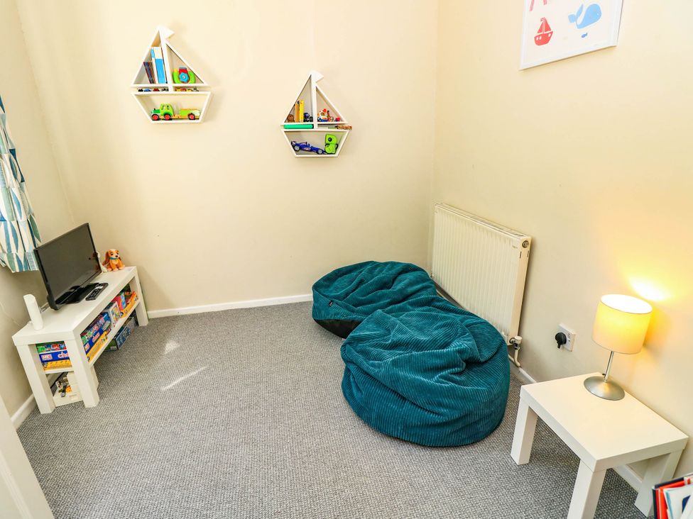 A children's room with bean bags and shelves at Altair Colwell Bay near Freshwater